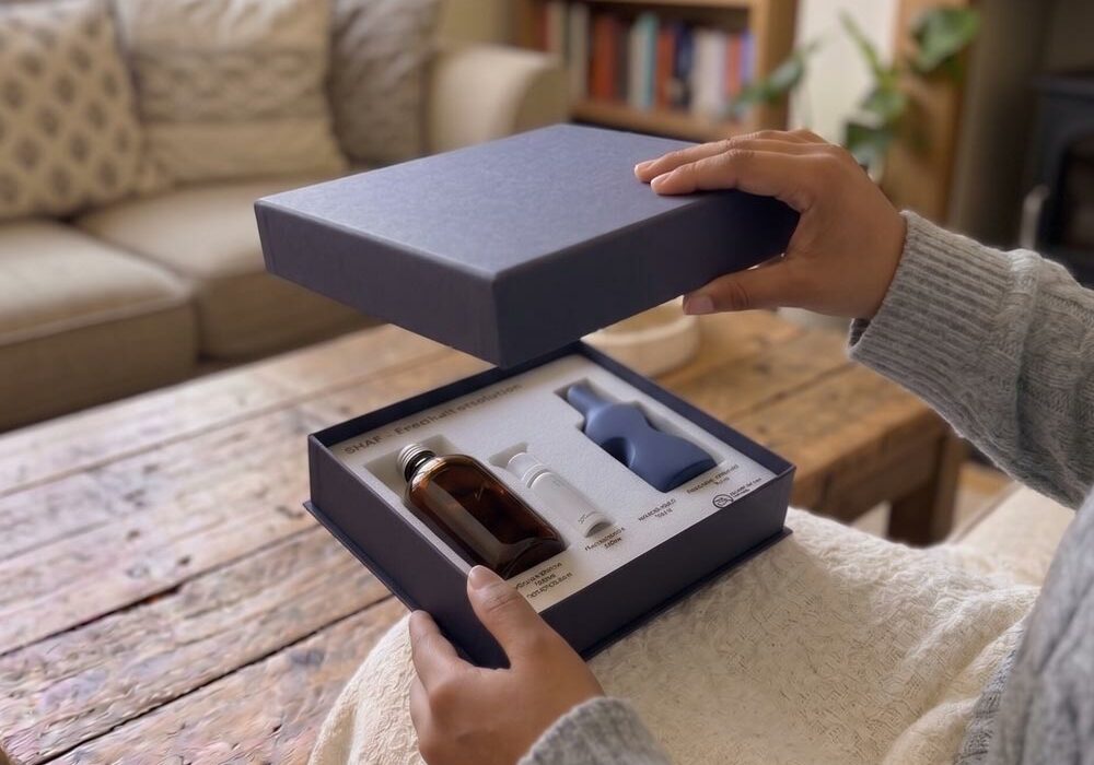 Custom foam packaging inserts A person opening a gift box with custom foam packaging inserts