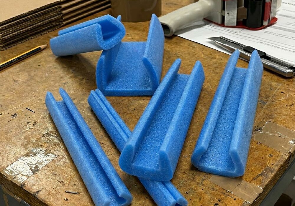 Edge protection foam strips on a workbench in a fulfilment centre